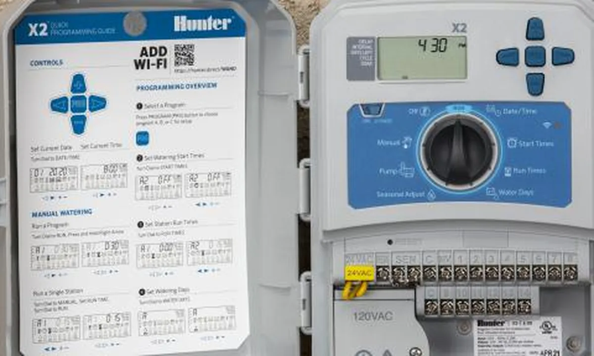 Homeowner adjusting sprinkler schedules on a smartphone app